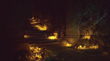 Mysterious candlelit path in ancient cave during twilight hours video