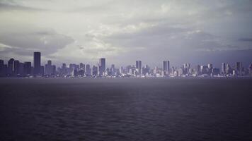 A serene view of a city skyline over the water during twilight hours video