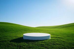 Circular platform on lush green grass under a clear blue sky in a serene landscape setting. Round podium. photo