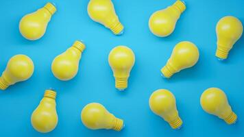 Scattered Yellow Lightbulbs on a Blue Background photo