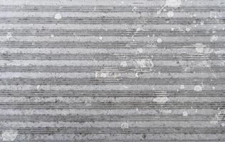 Textured metallic surface with stains and grooves. photo