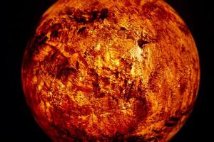 A mock-up of the planet Mars illuminated from the inside on a dark background. photo