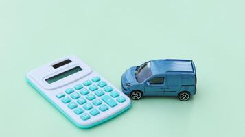 Model car and calculator on notebook with blur background. Planning of saving for buying car, car loan and car insurance concept. photo