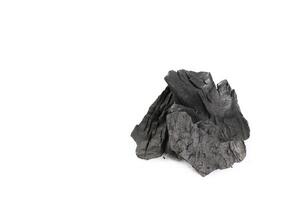 Isolated pieces of black charcoal resting on clean white background, showcasing its rough texture and deep, rich color. Often used for grilling, art, and filtration. photo