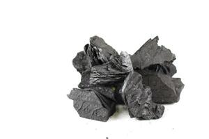 Isolated pieces of black wooden charcoal resting on white background, showcasing its rough texture and deep, rich color. Often used for grilling, art, and filtration. photo