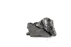 Isolated pieces of black charcoal resting on a clean white background, showcasing its rough texture and deep, rich color. Often used for grilling. photo