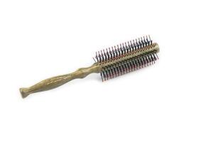 A classic hairbrush with metal bristles and a wooden handle is cut out with clipping paths on a white background. photo
