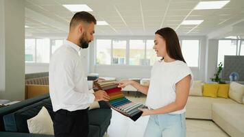 Salesman Assists Customer with Fabric Selection in Store video