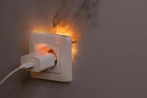 Electrical Short Circuit in Wall Socket with Sparks photo