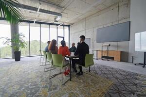 A diverse multiethnic business team engages in a collaborative meeting, discussing strategies and solutions in a modern office setting photo