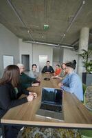 A diverse multiethnic business team engages in a collaborative meeting, discussing strategies and solutions in a modern office setting photo