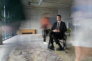 A businessman in a wheelchair navigating through a busy office, surrounded by his colleagues who are actively engaged in their work and collaboration photo