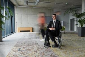 A businessman in a wheelchair navigating through a busy office, surrounded by his colleagues who are actively engaged in their work and collaboration photo