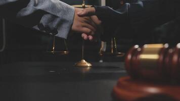 Two business people shaking hands over a gavel video