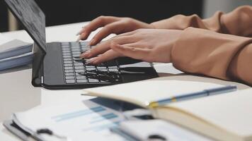 A person typing on a laptop computer video