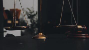Two scales on a table with a gavel in the background video