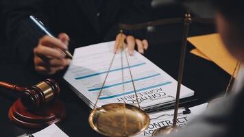 A lawyer signing a document with a scale video