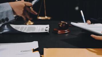 A lawyer is holding a pen and paper while a man is writing on a notepad video