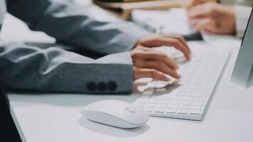 A person typing on a computer keyboard video