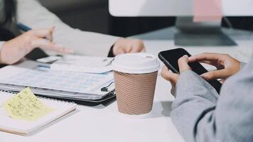 Business people using their phones at a desk video