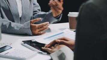 Two business people talking at a table with a cup of coffee video