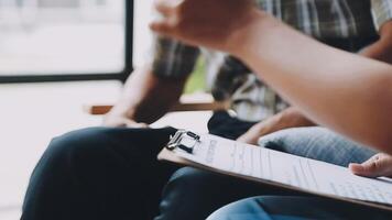 A person is holding a clipboard while sitting on a couch video