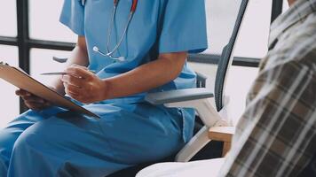A nurse is sitting in a chair with a clipboard video
