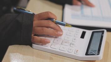 A person is using a calculator on a desk video