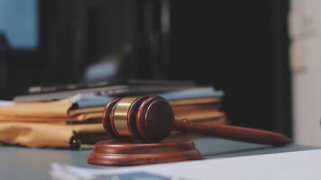 Judge gavel on desk with papers and books video