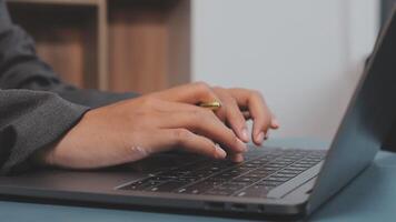 A person typing on a laptop computer video