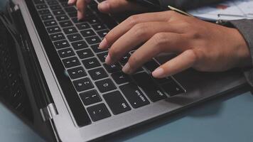 A person typing on a laptop keyboard video