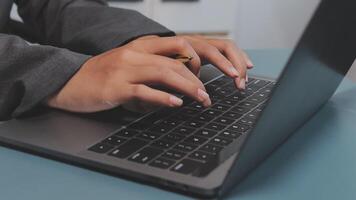 A person typing on a laptop computer video