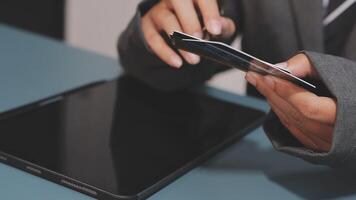 A person in a suit holding a credit card video