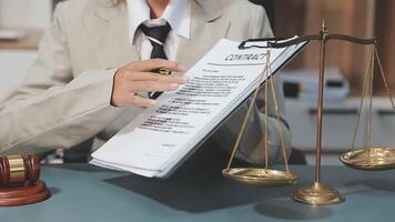 A woman in a suit holding a paper with a document on it video