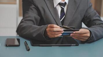 A man in a suit holding a credit card video