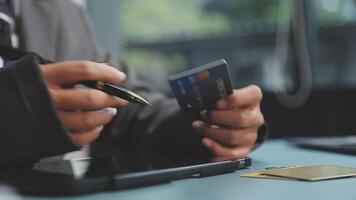 A man in a suit holding a credit card and pen video