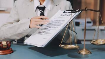 A woman in a suit holding a paper with a contract on it video