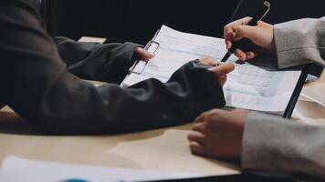 Two people are working on a document at a table video