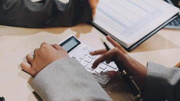 Business people using calculator at desk video