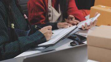 Two women are working on paperwork at a desk video