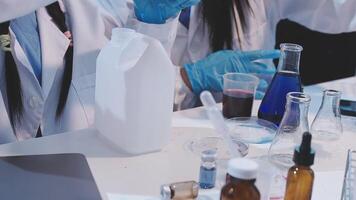 Two people in lab coats are working on a project video