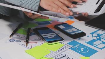 A person is using a calculator and a phone on a desk video