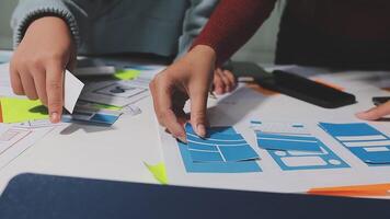 Two people working on a project with paper and scissors video