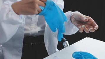 A person in a lab coat is holding a blue plastic bag video