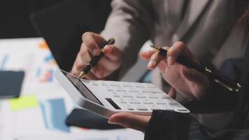 Business people using calculator to calculate the cost of a project video