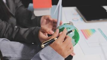 Business people working on a project with a globe video