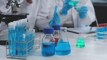 Two people in lab coats are working on a project video