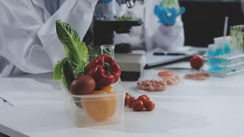 A man in a lab coat is holding a container of vegetables video
