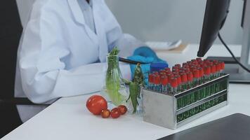 A man in a lab coat is working on a computer video