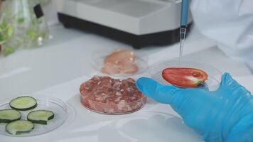 A person in a lab coat is holding a food sample video